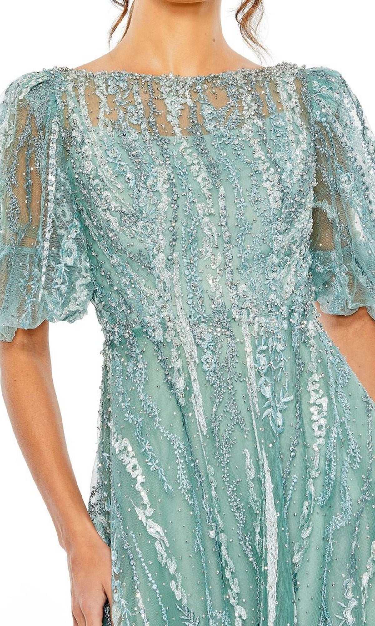 A woman wears the Mac Duggal 20485 Embroidered Wedding-Guest Dress in light blue, featuring beading, sheer short puff sleeves, and intricate embroidery; shown from shoulders to mid-thigh.